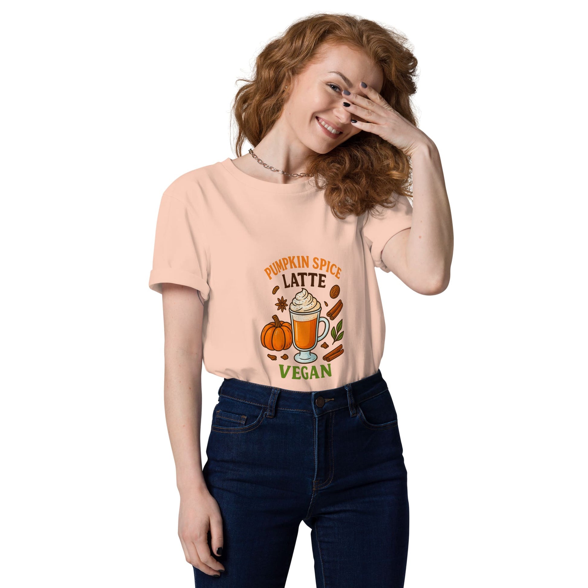 Woman wearing a peach t-shirt with 'Pumpkin Spice Latte Vegan' design on a white background