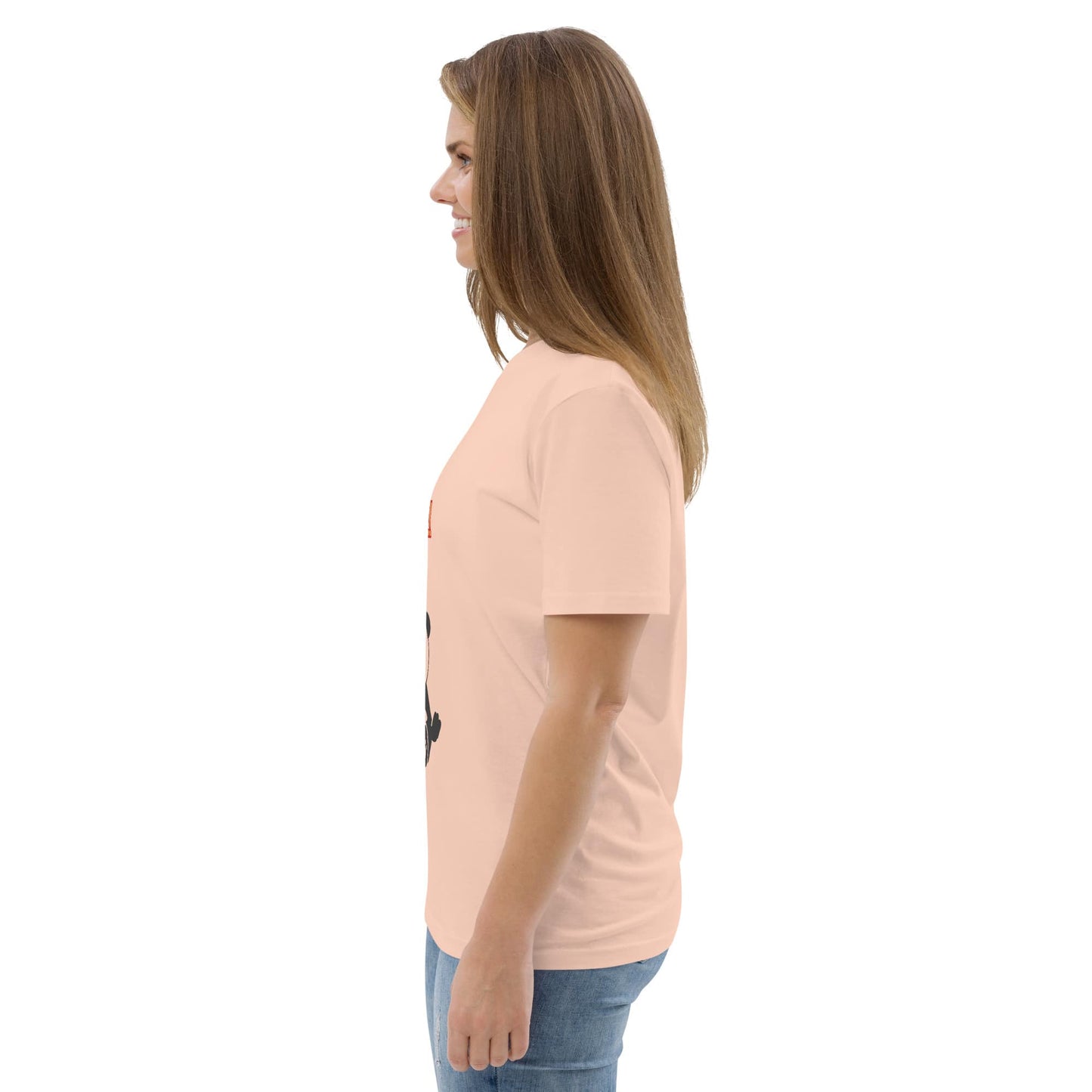 Side view of a woman in a peach organic cotton panda meditation tee, revealing the shirt's flattering silhouette and soft, natural drape.