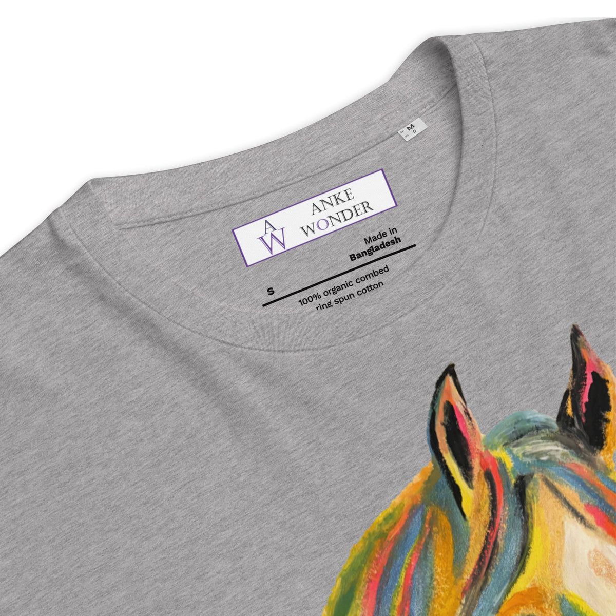 Close-up of a heather gray t-shirt showing the inner neck label with 'ANKE WONDER' and a colorful painted horse graphic on the right side.