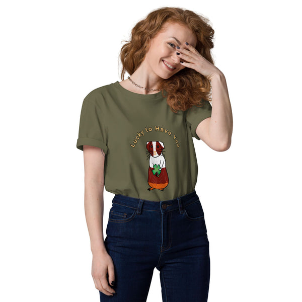 Woman wearing a green khaki organic cotton t-shirt tucked into jeans, showcasing a guinea pig holding a shamrock with "Lucky to Have You" text above.