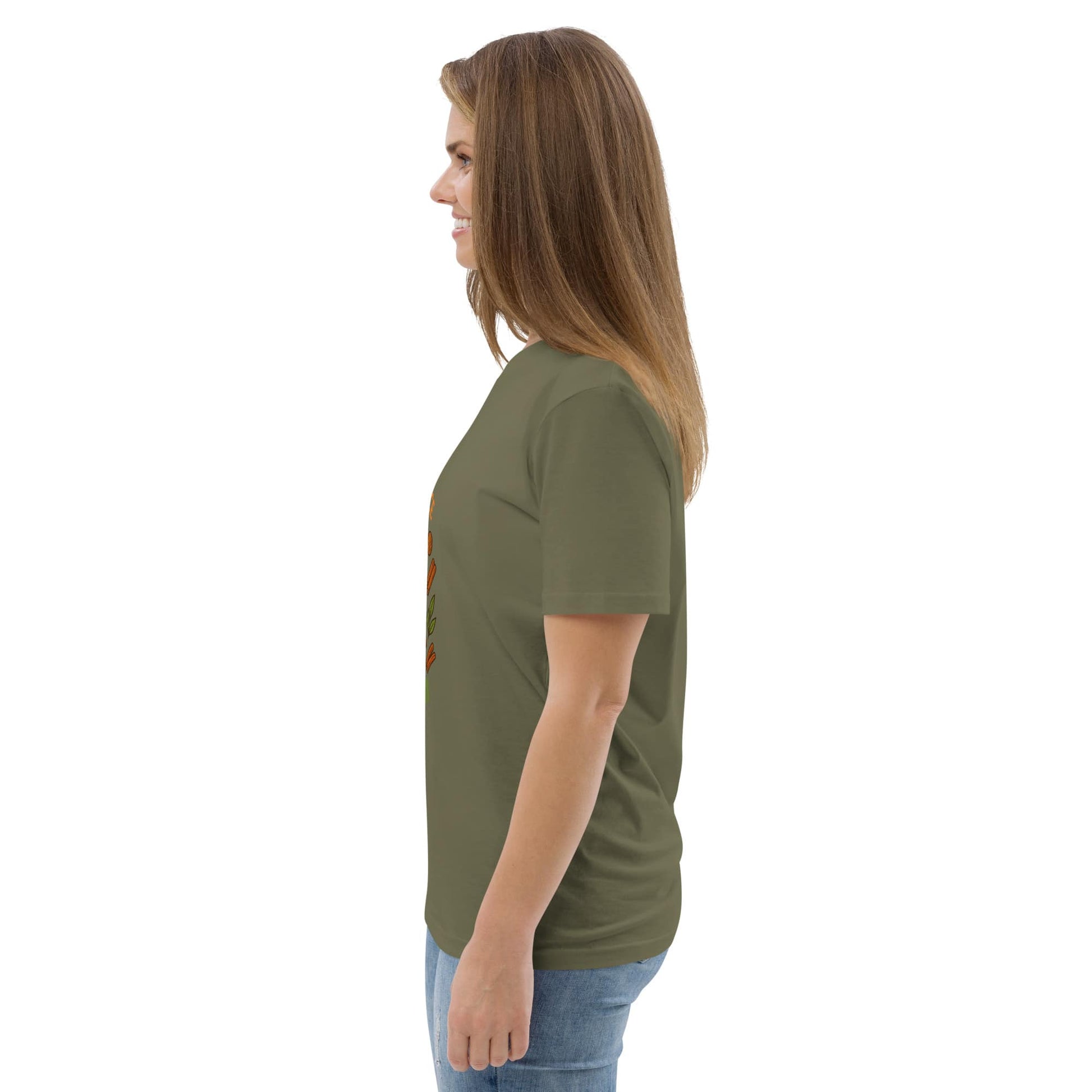 Side view of woman wearing a green t-shirt with a small graphic on a white background