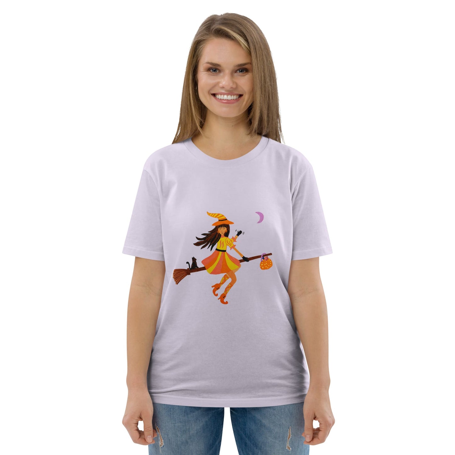 Woman wearing a white t-shirt with a graphic design of a witch on a broomstick.