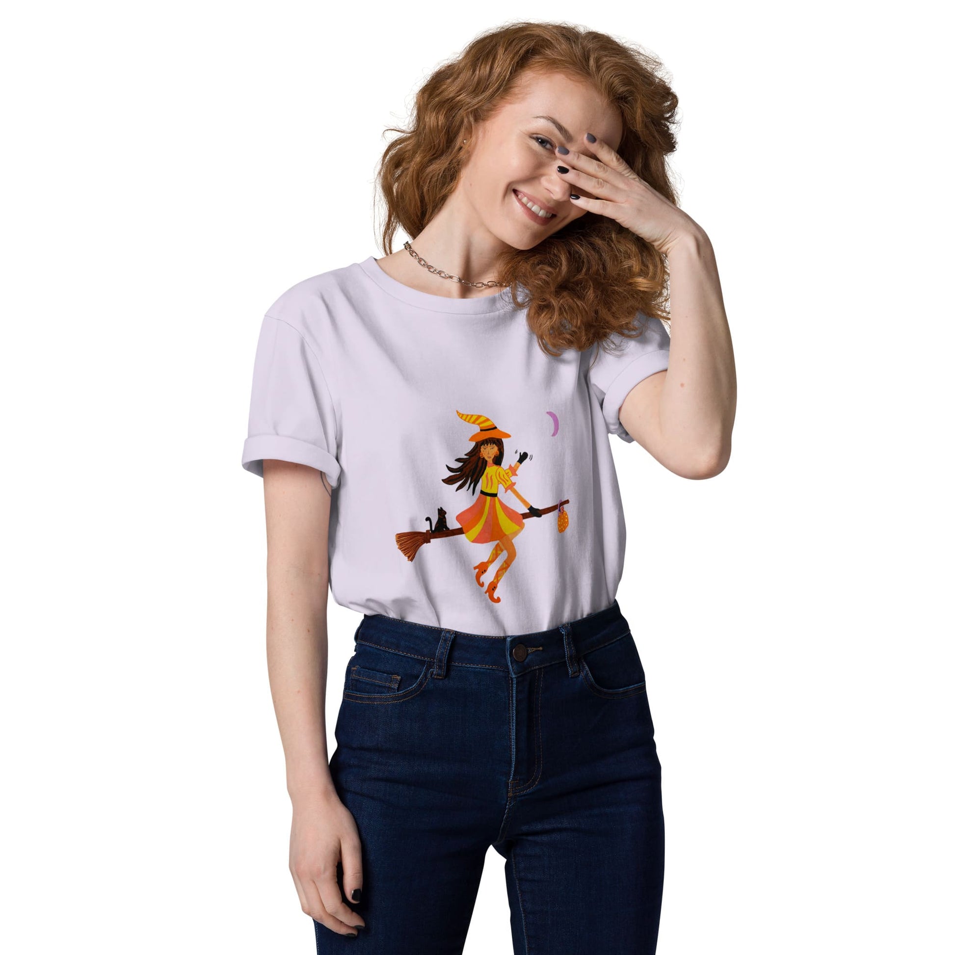 Woman wearing a lavender t-shirt with a halloween witch design on a white background
