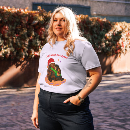 Woman wearing a lavender t-shirt with a Christmas-themed design outdoors.