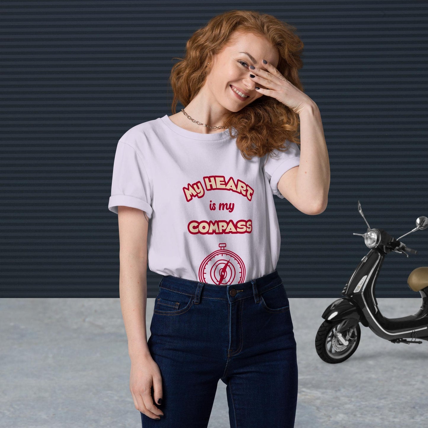 Front view of woman wearing tucked-in lavender organic cotton t-shirt with red 'My Heart is My Compass' design — stylish and sustainable spiritual clothing.