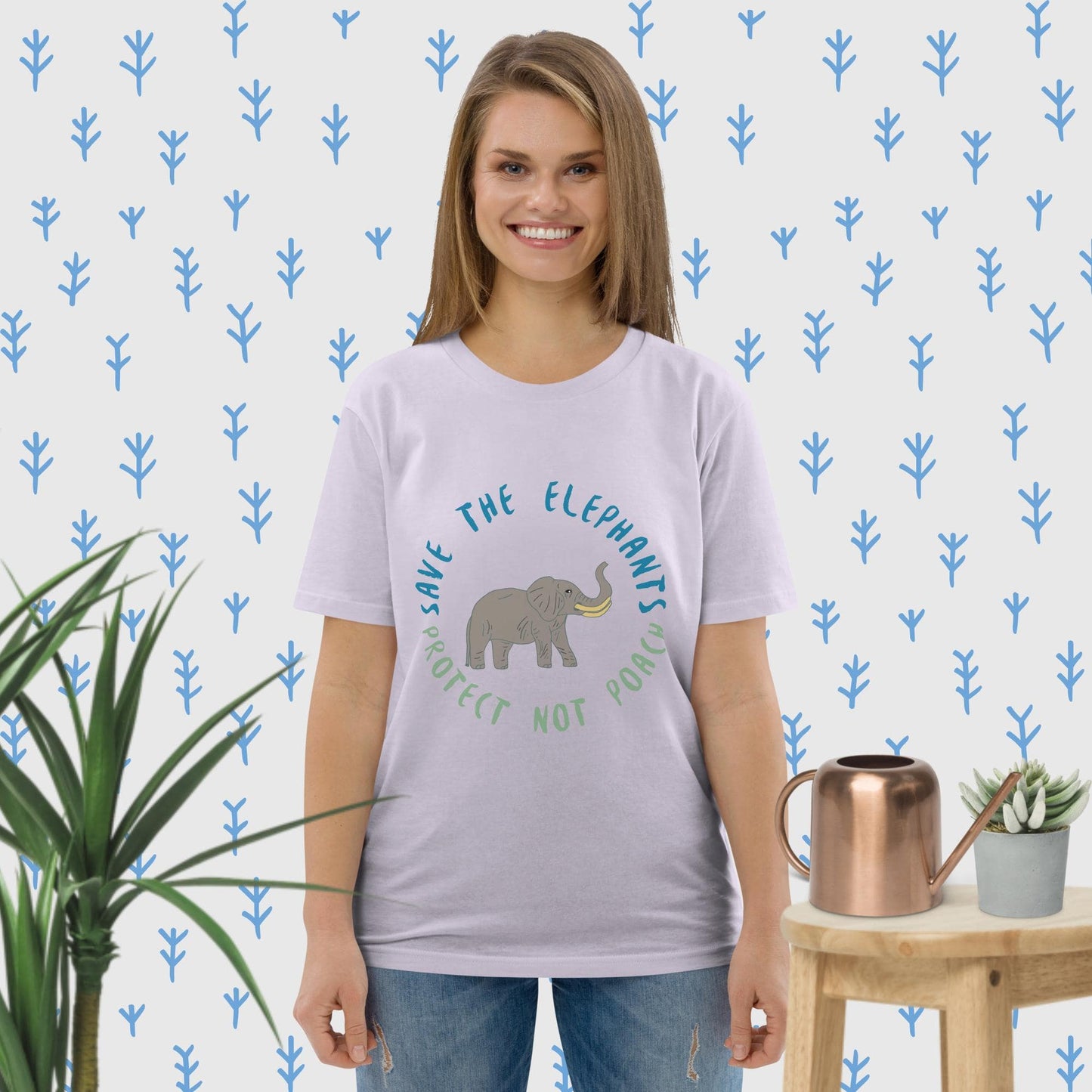 Woman in lavender organic cotton tee featuring a cute elephant illustration and “Save the Elephants – Protect Not Poach”; clean front view.