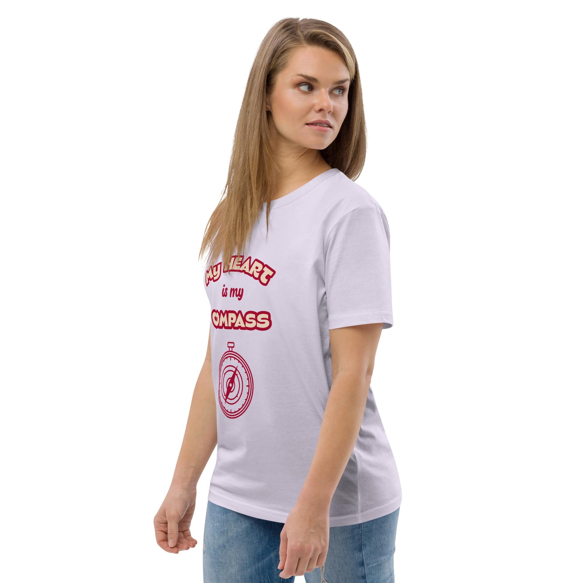 Front left view of woman wearing organic cotton t-shirt in lavender with red ‘My Heart is My Compass’ design — casual spiritual clothing made from eco-conscious fabric.