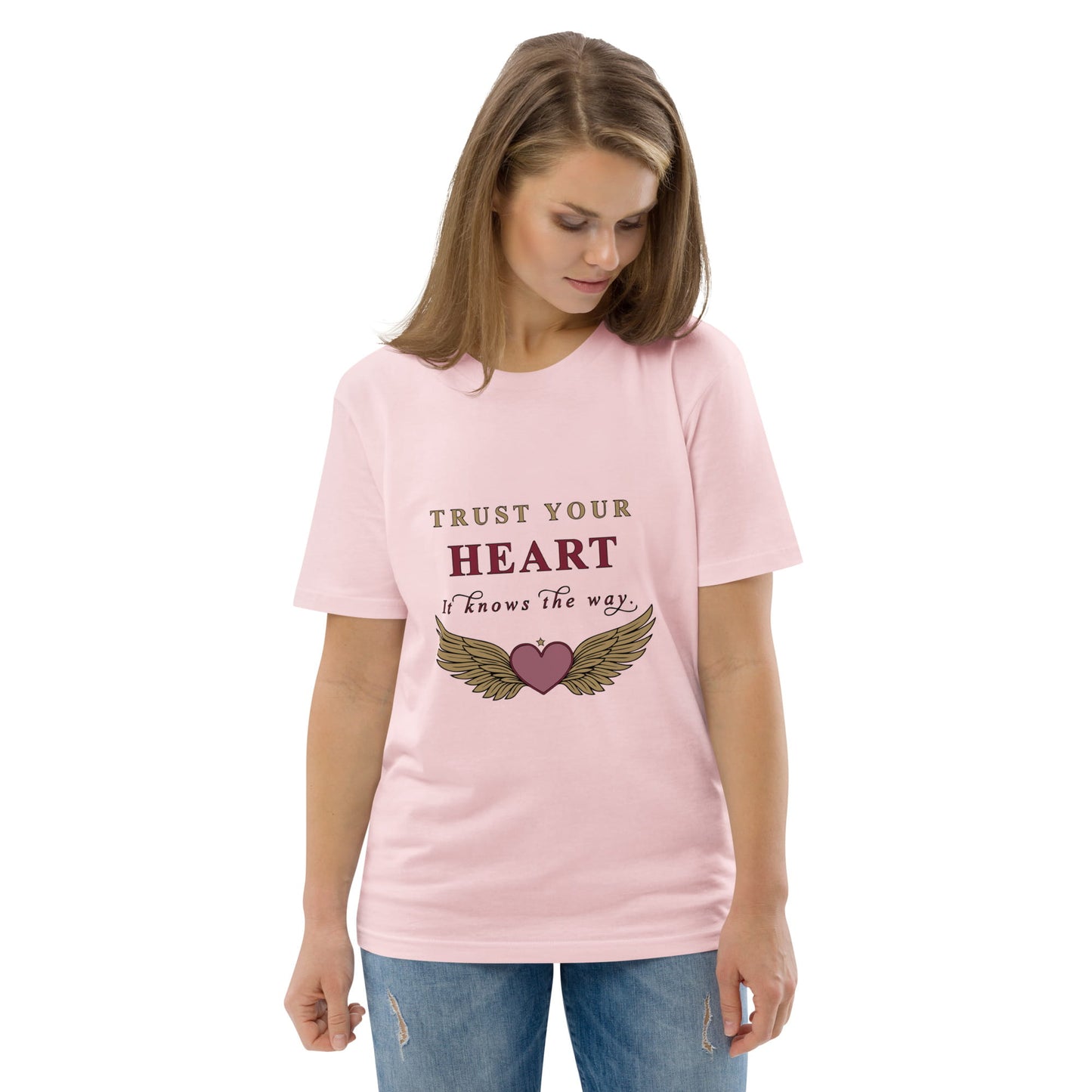 Woman wearing a pink t-shirt with a motivational quote 'Trust your heart. It knows the way' on a white background