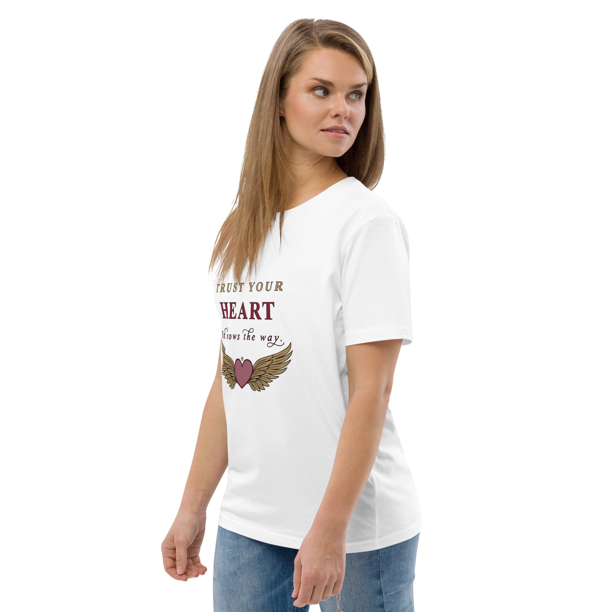 Woman wearing a white t-shirt with a motivational quote on a plain background