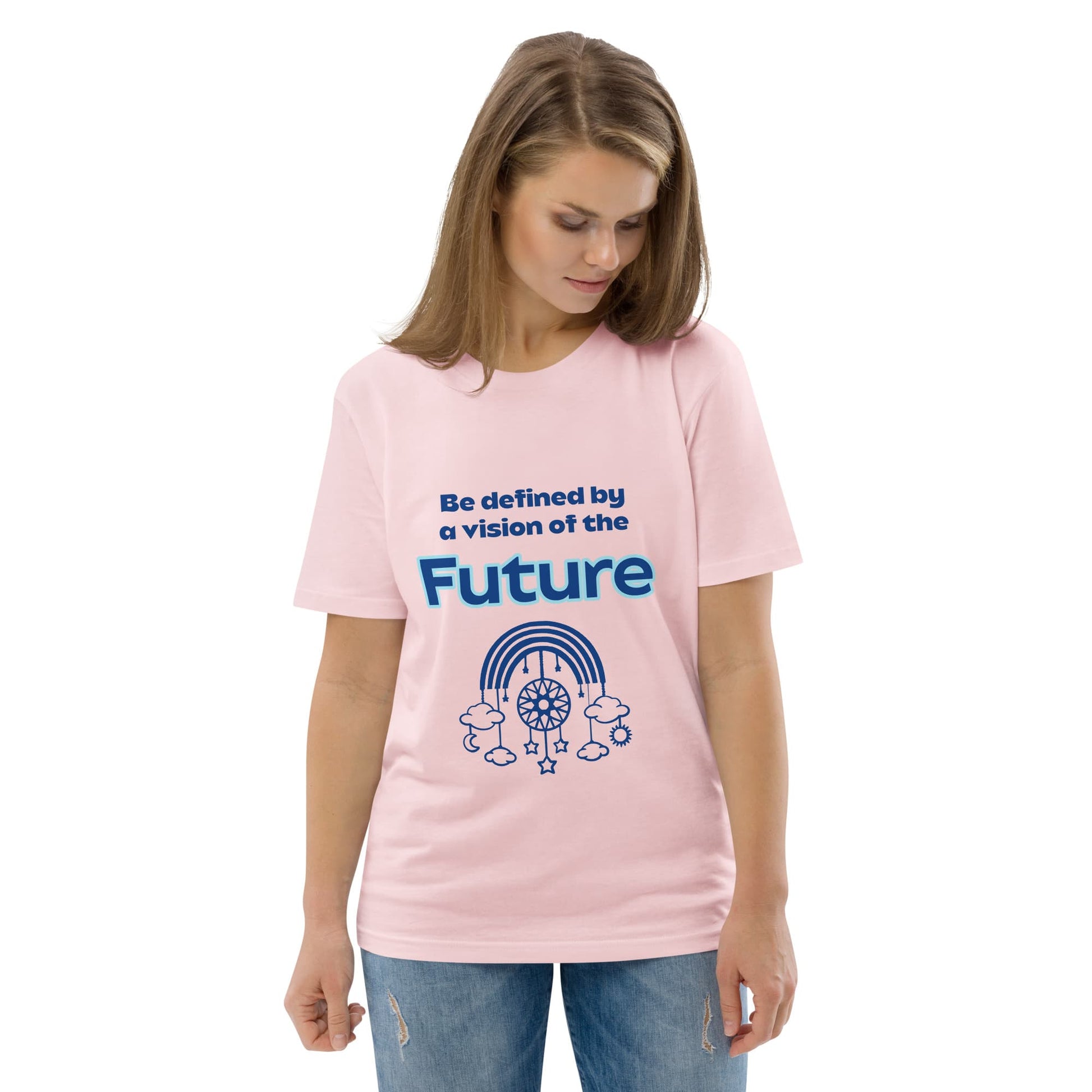 Woman wearing an organic cotton t-shirt in pink with “Be defined by a vision of the Future” design featuring a dream catcher with rainbow, stars, and clouds.