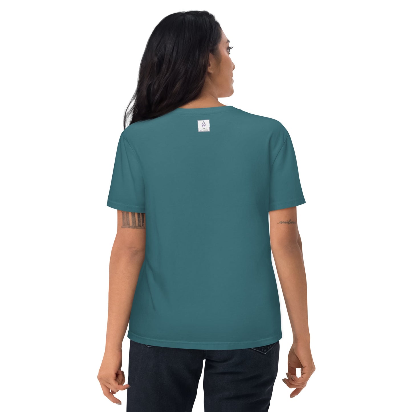 Woman showing the backside of the organic cotton t-shirt in stargazer color, highlighting the neck label and fit.