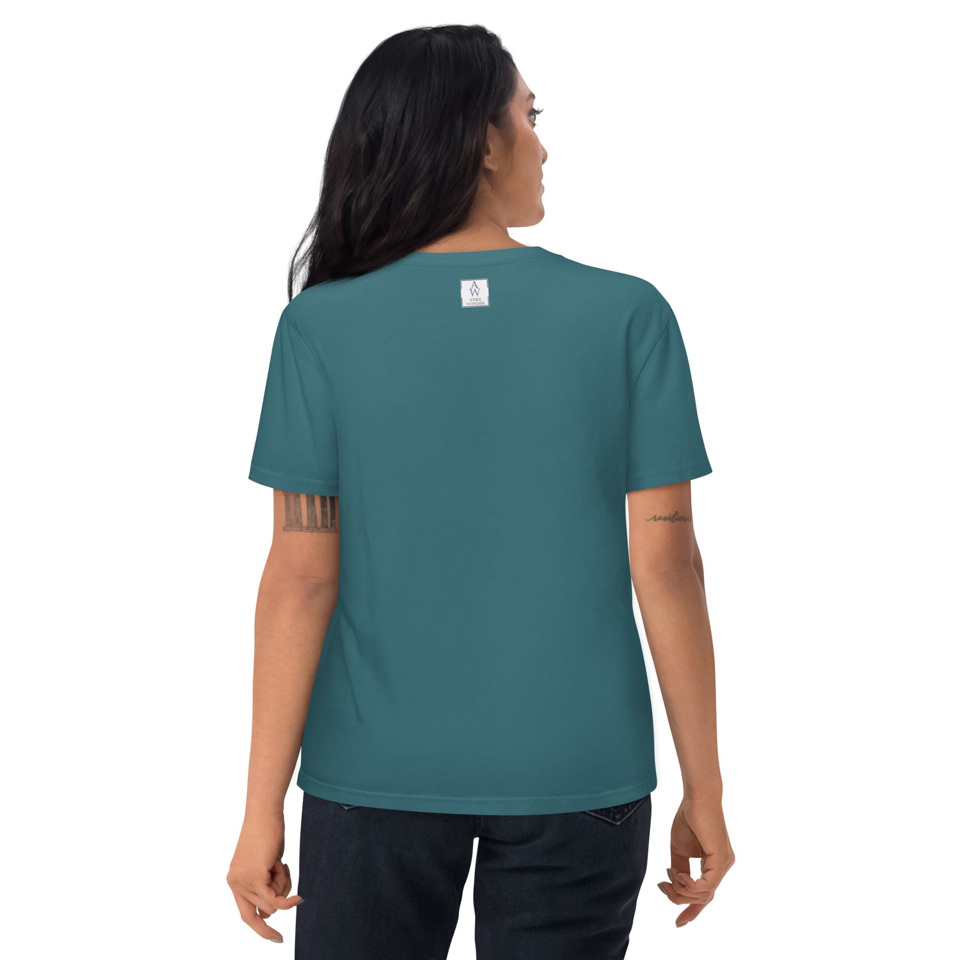 Woman showing the backside of the organic cotton t-shirt in stargazer color, highlighting the neck label and fit.