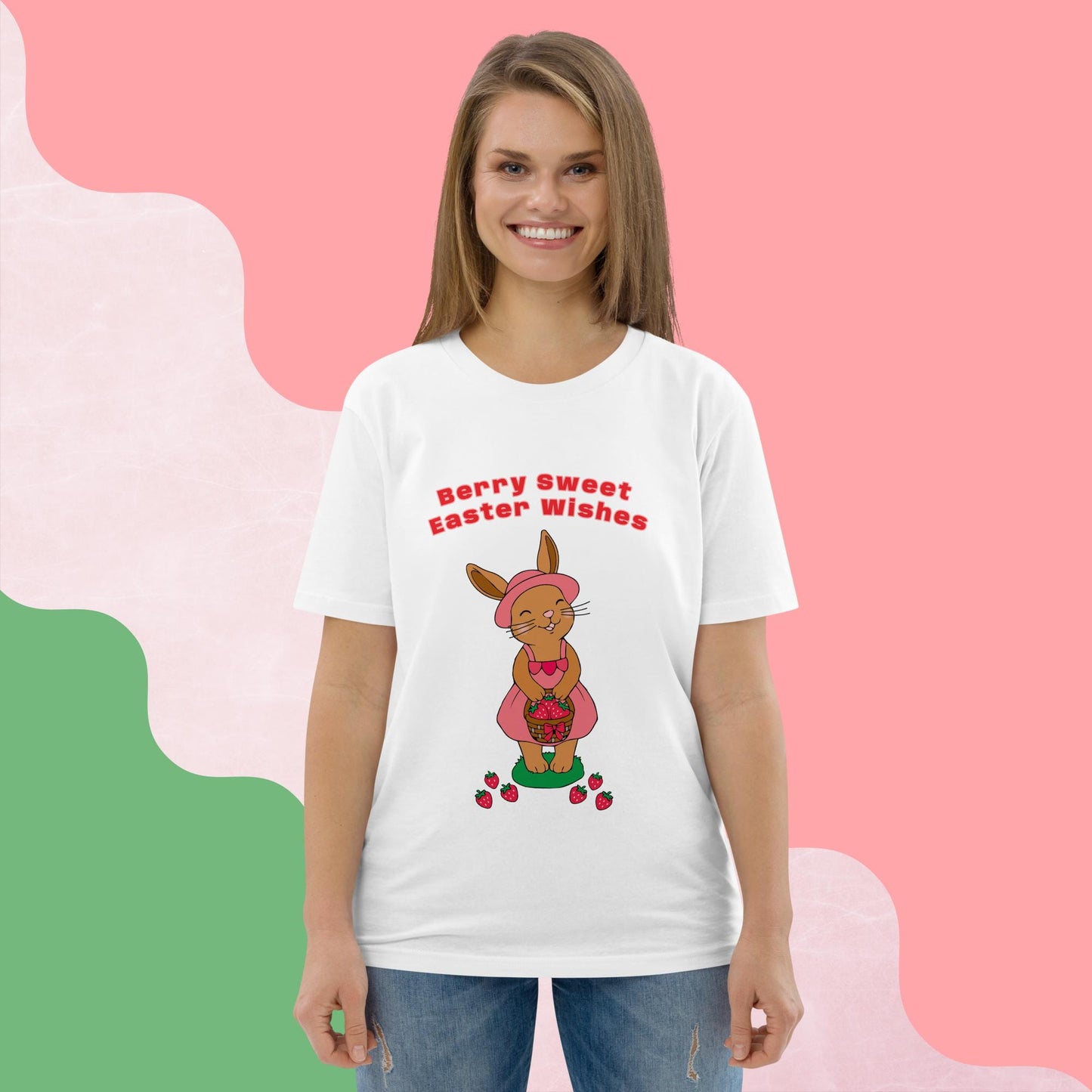 Woman wearing a white t-shirt with an Easter-themed bunny and strawberry design on a pink background