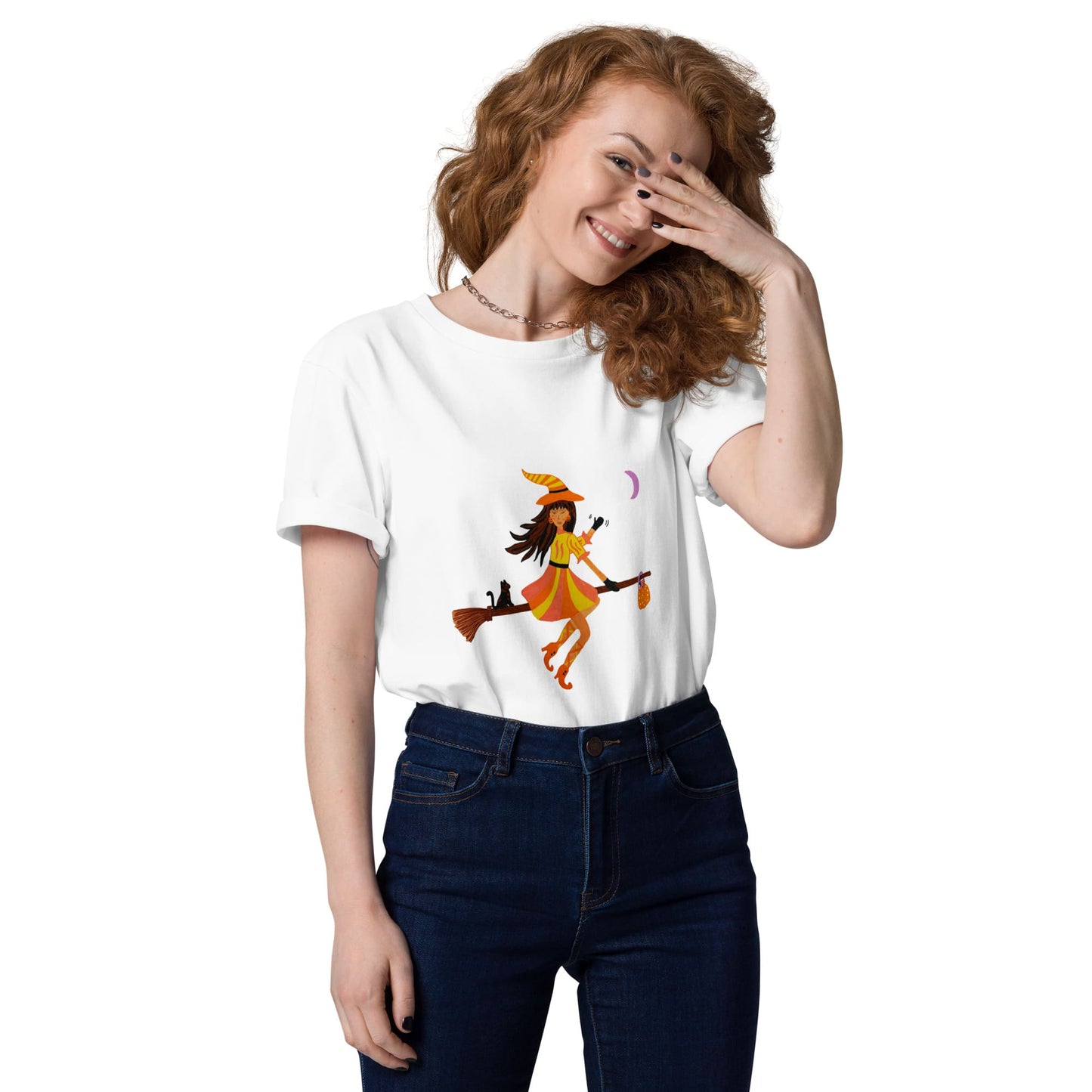 Woman wearing a white t-shirt with a colorful halloween witch design on a white background