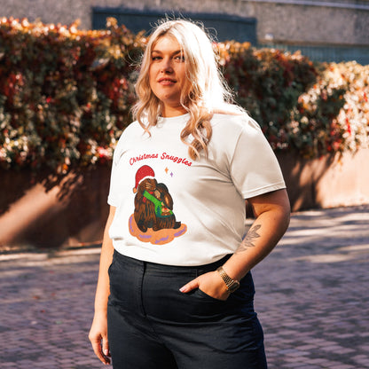 Side view of woman wearing a white t-shirt with a rabbit Christmas graphic design and text 'Christmas snuggles', standing outdoors