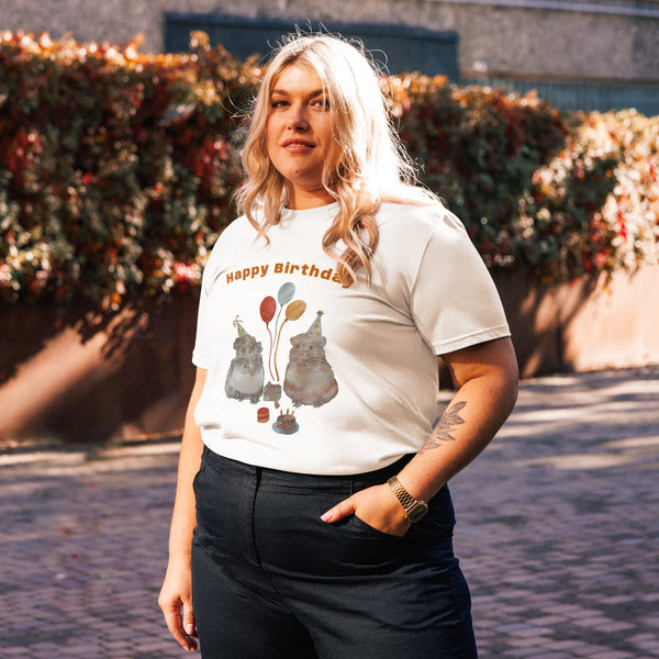 Side view of woman wearing a white t-shirt with a with guinea pig drawing and text 'Happy Birthday' outdoors
