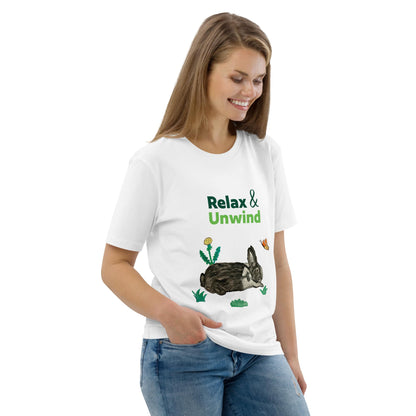 Woman wearing white organic cotton t-shirt with Relax & Unwind design — hand-painted rabbit, butterfly, and greens — front view, right angle.