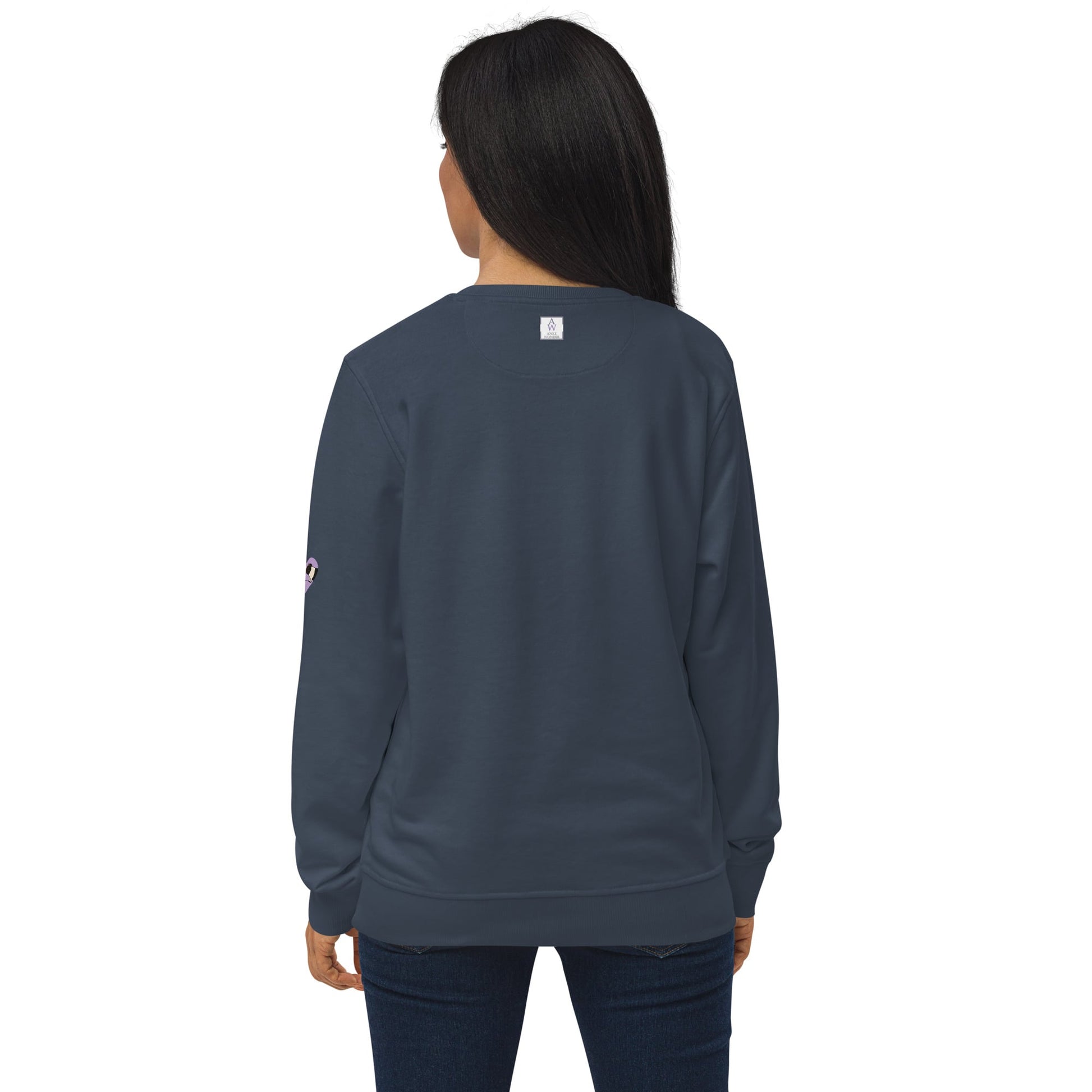Back view of woman wearing a navy sweatshirt, displaying the Anke Wonder logo on the upper back.