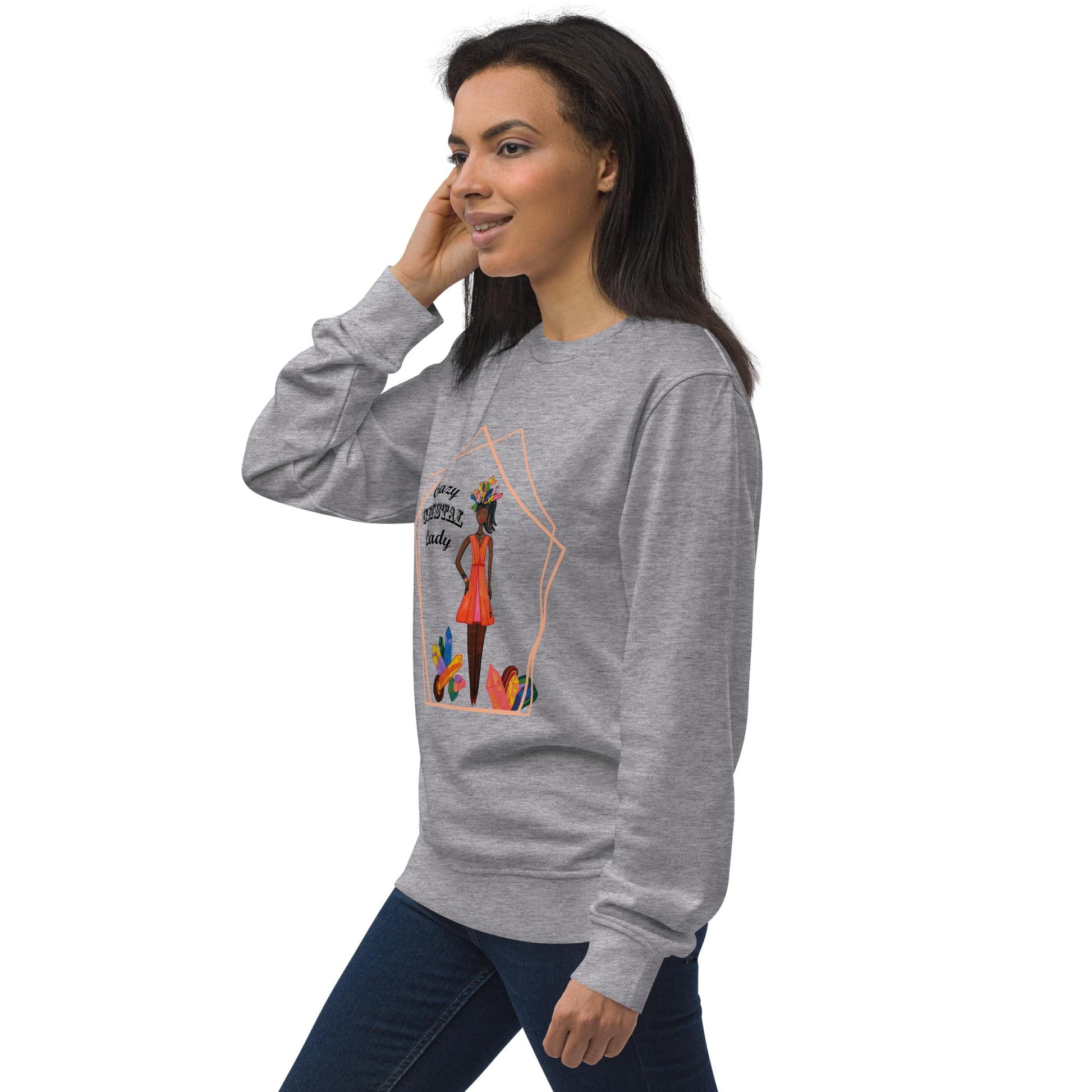 Right view of woman wearing a gray sweatshirt with a colorful graphic design  of a black woman with the words 'Crazy Crystal Lady' on a white background