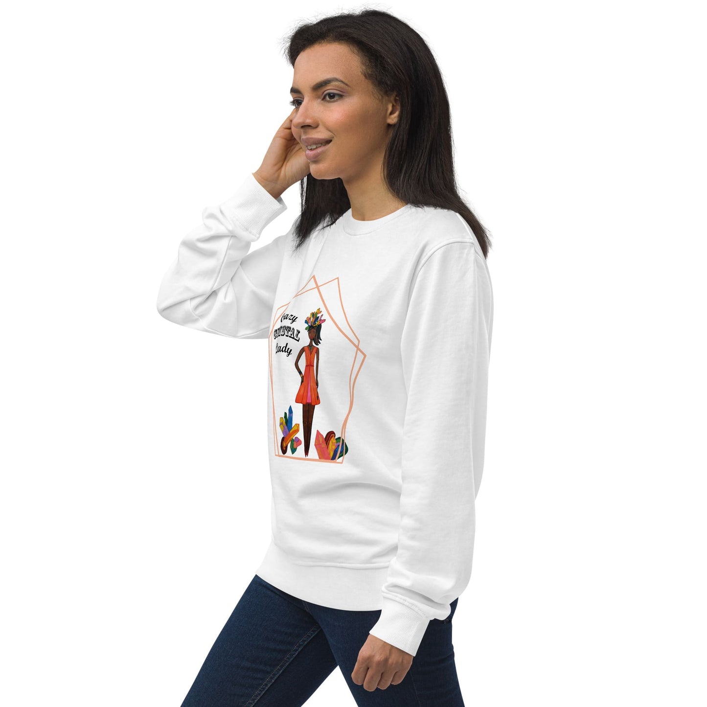 Right view of woman wearing a white sweatshirt with a colorful graphic design  of a black woman with the words 'Crazy Crystal Lady' on a white background