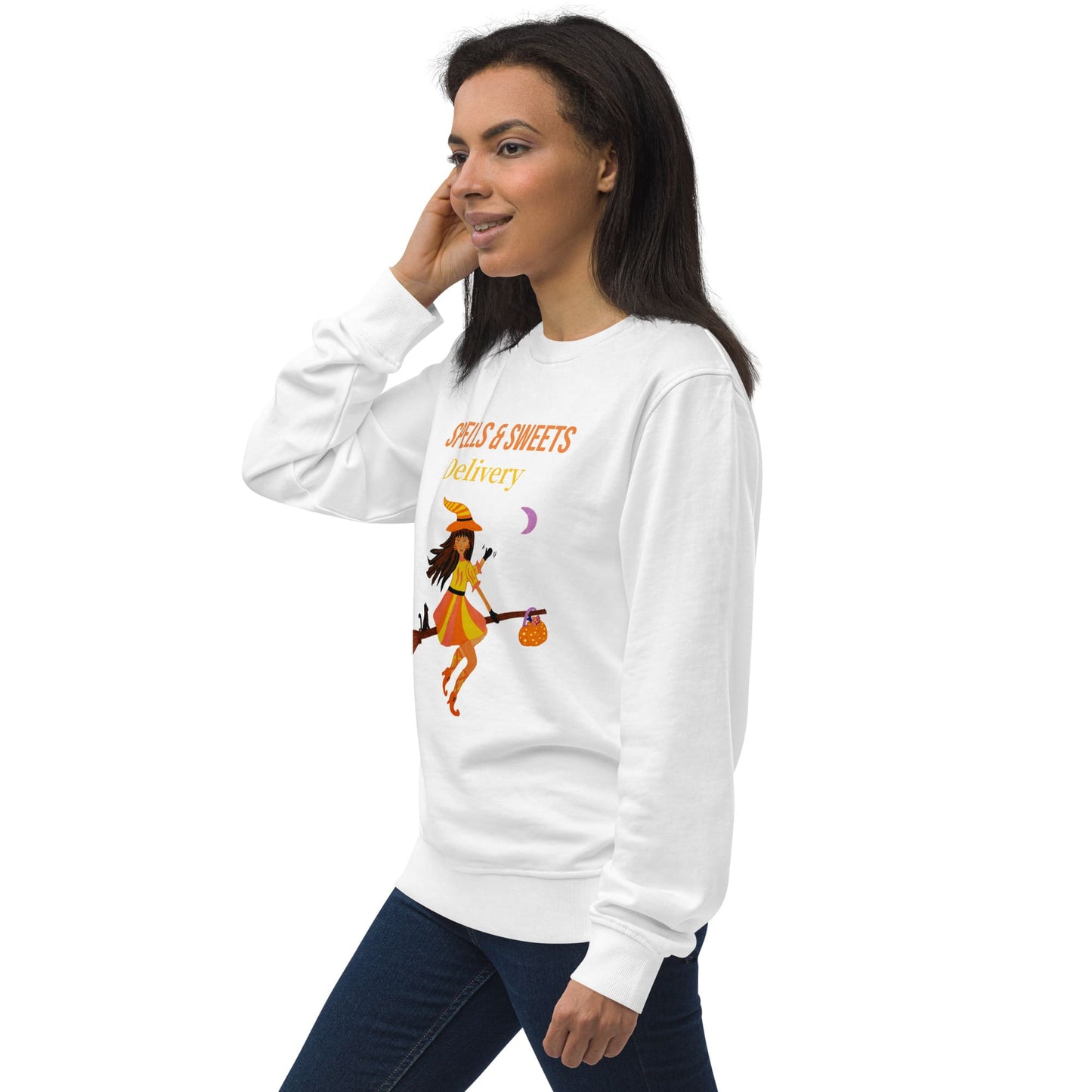 Woman wearing a white sweatshirt with a 'Spells & Sweets Delivery' Halloween design on a white background