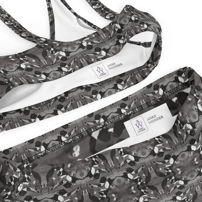 Black and white  bikini with tropical bird print and brand label Anke Wonder on a white background.