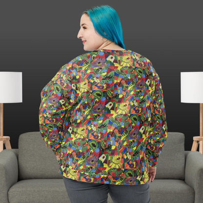 Woman wearing a colorful patterned shirt with butterflies and flowers in a room with gray chairs and white lamps.