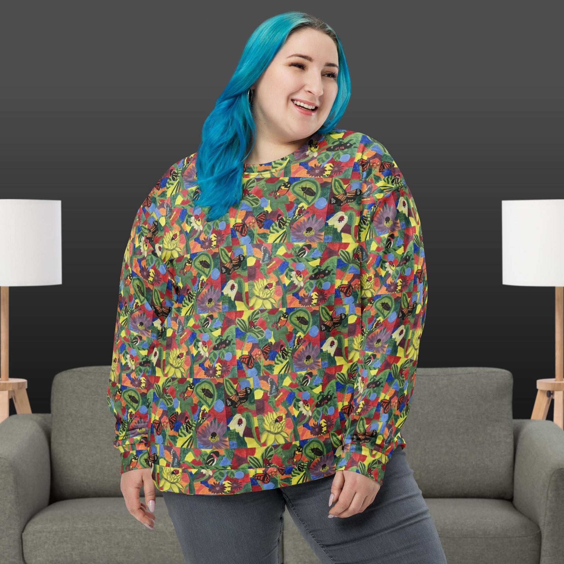 Woman wearing a colorful patterned shirt with butterflies and flowers in a room with gray chairs and white lamps.