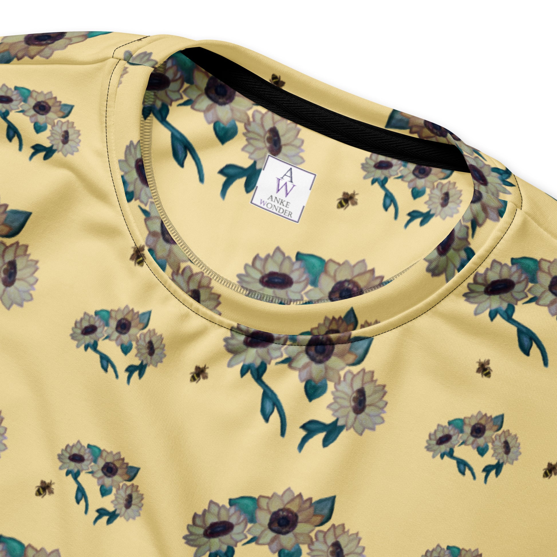 Yellow shirt with floral pattern and brand label Anke Wonder on a white background