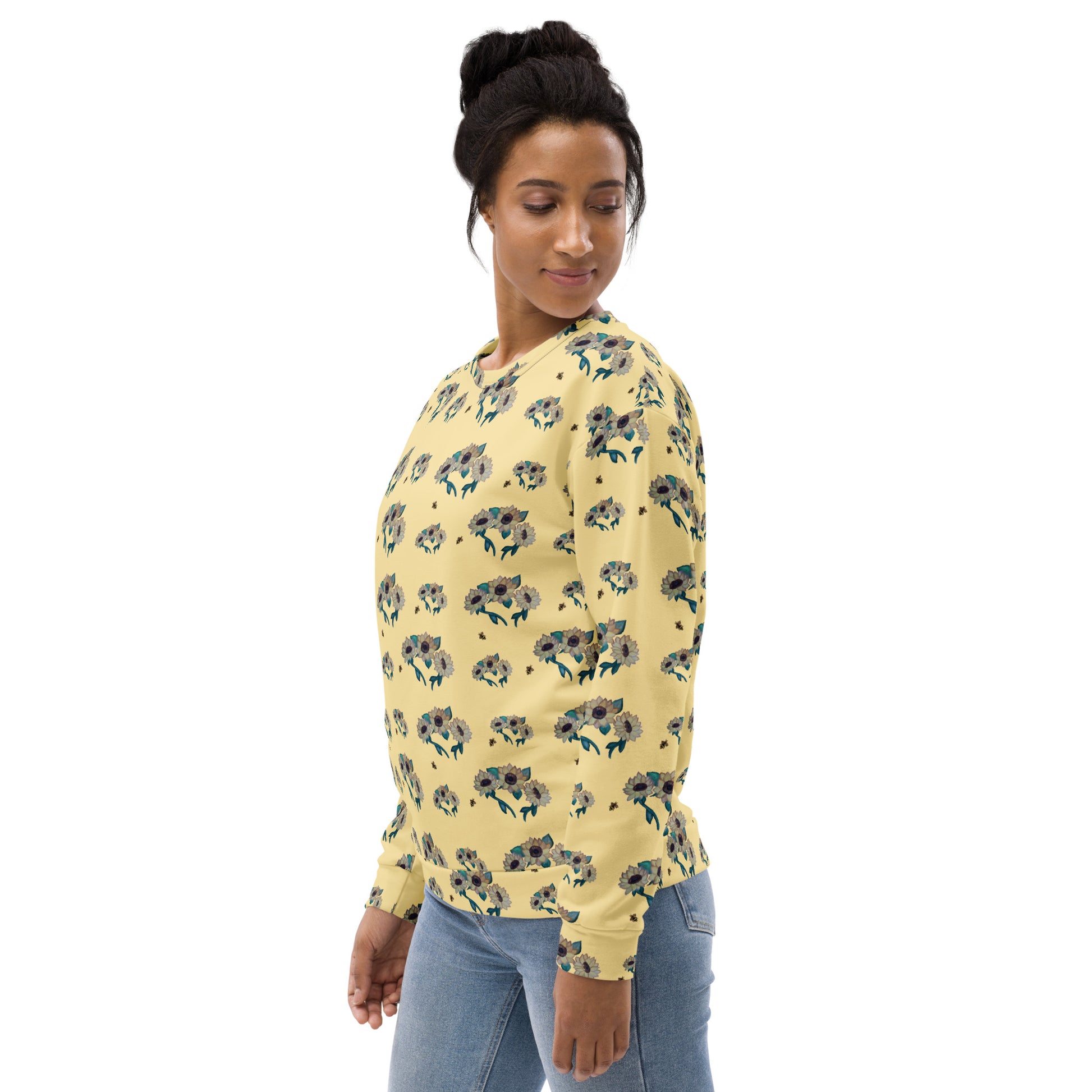 Woman wearing a yellow floral-patterned sweatshirt on a white background