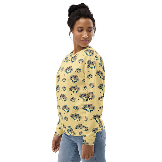 Woman wearing a yellow floral-patterned sweatshirt on a white background