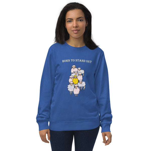 A woman wearing a blue organic cotton sweatshirt with a design of a yellow sheep among white sheep and the text "Born to Stand Out.