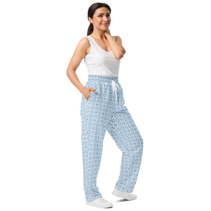 Left-front view of the wide-leg joggers, featuring the bold blue geometric pattern and side pocket detail.