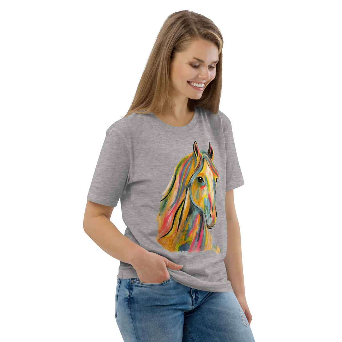 A woman wearing a heather gray t-shirt with a colorful watercolor-style graphic of a horse on the front, paired with blue jeans, set against a plain white background.