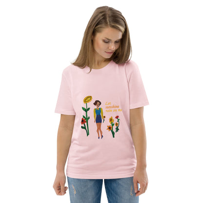 Woman wearing a pink t-shirt with a sunflower lady design and text 'Let sunshine rain on me' on a white background