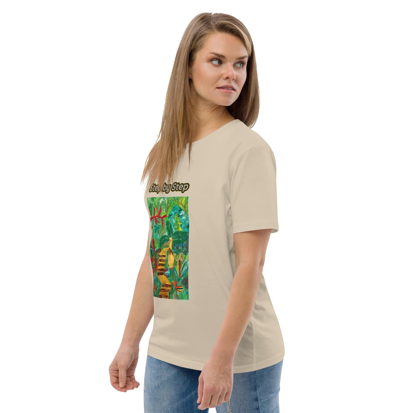 Woman wearing a beige t-shirt with a colorful artwork of greenery on a white background