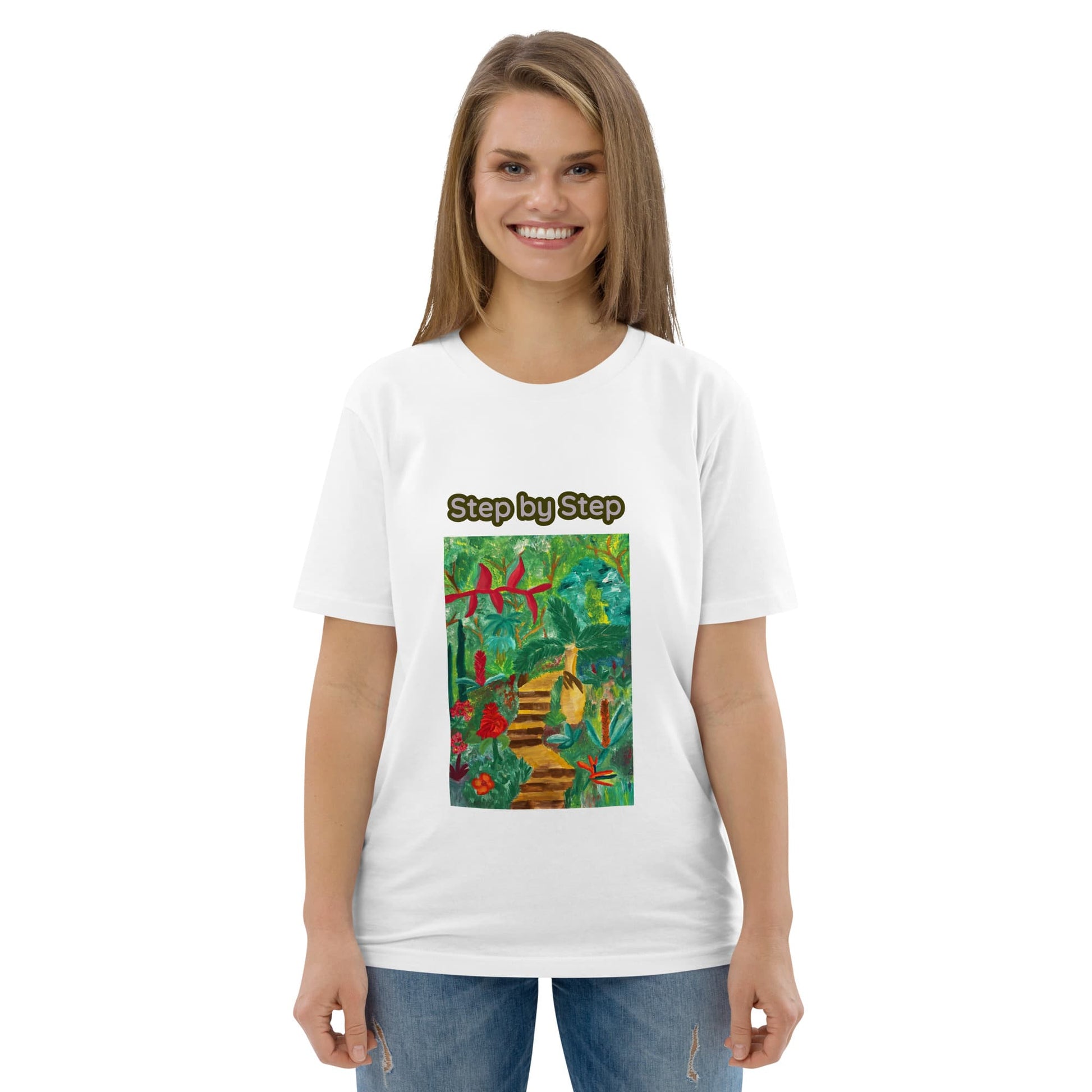 Woman wearing a white t-shirt with a colorful graphic of the tropics and 'Step by Step' text on a white background