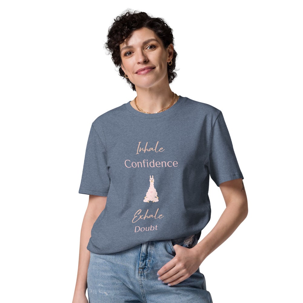 Woman wearing a heather grey organic cotton t-shirt with "Inhale Confidence, Exhale Doubt" quote and a pink llama illustration.