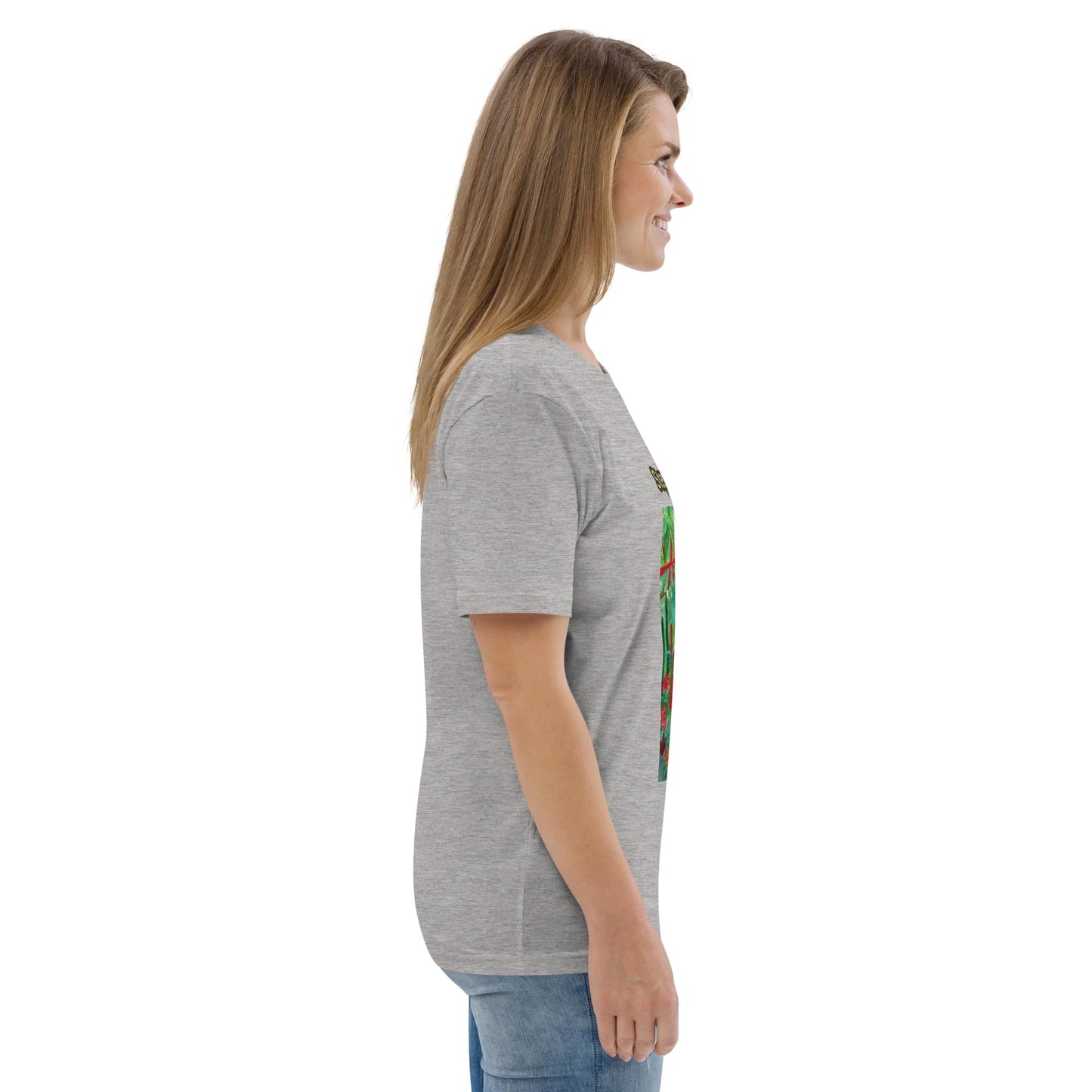 Side view of woman wearing a grey t-shirt with a tropical design on a white background