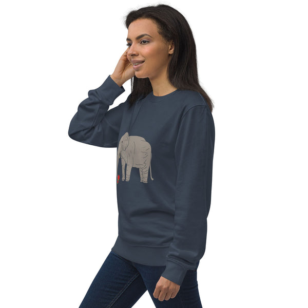 Side view of a woman wearing a navy organic sweatshirt, showcasing the relaxed fit and sustainable fabric. The design features an illustration of an elephant holding a red rose on the front.