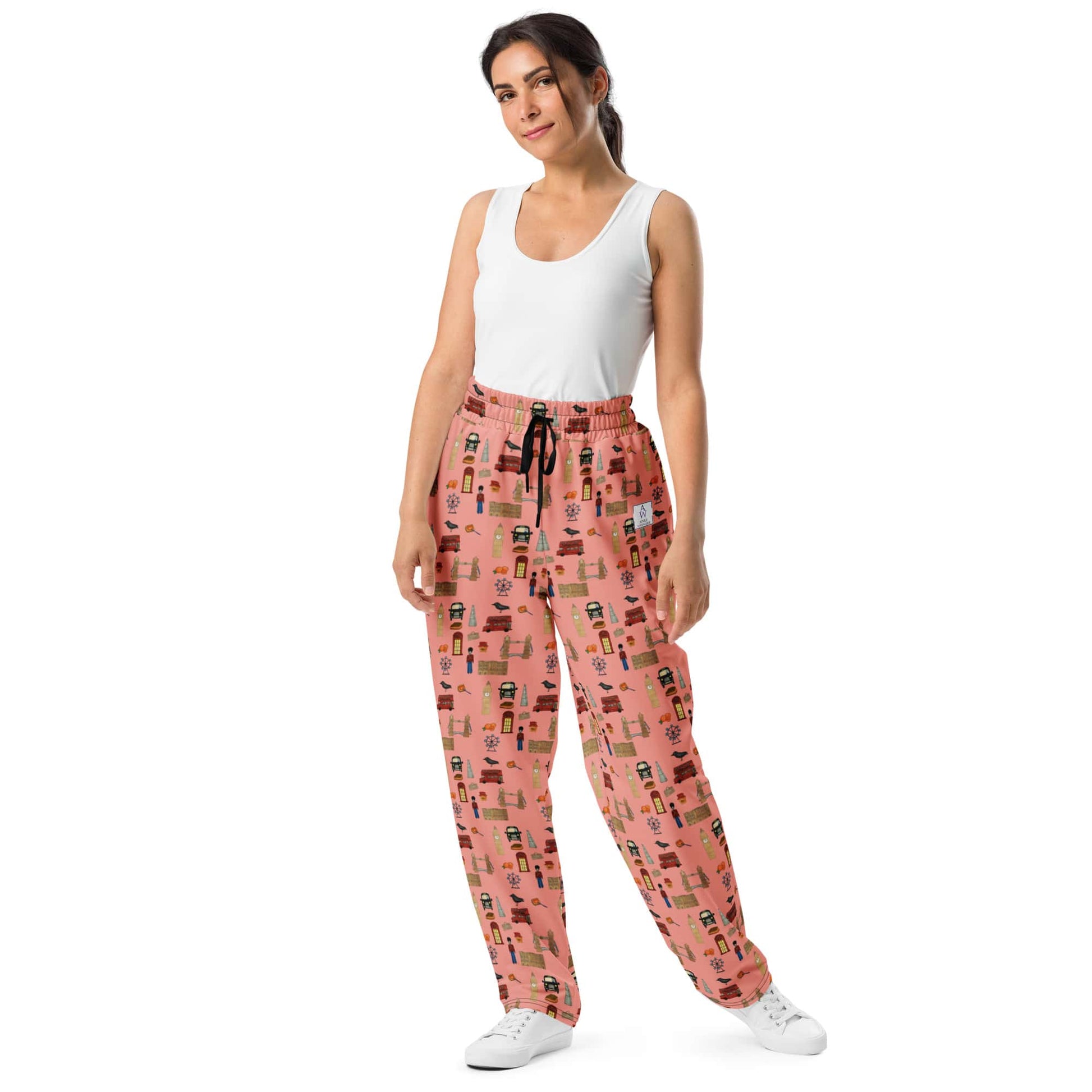 Front view of woman wearing London-themed recycled joggers with playful UK landmarks