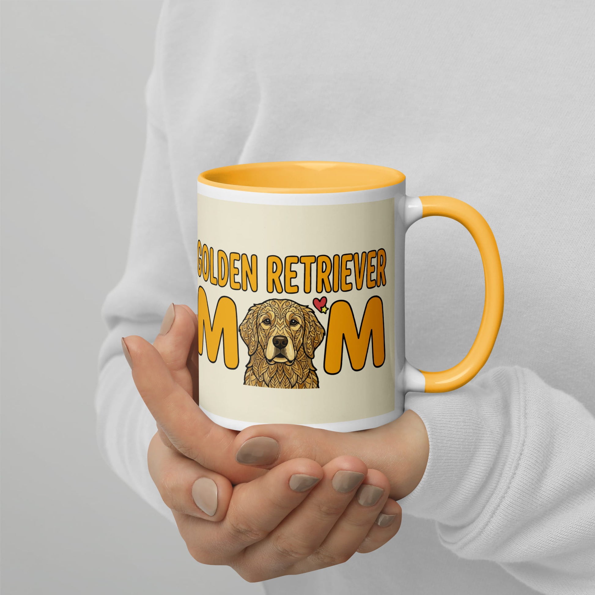 Mug with 'Golden Retriever Mom' text and a dog illustration held by a person.