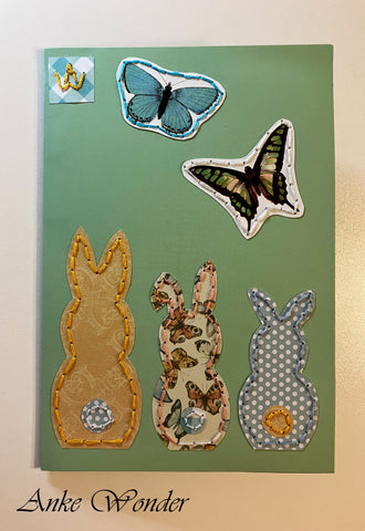 Hand-Embroidered greeting card with three colorful bunnies and butterflies  for gifting.