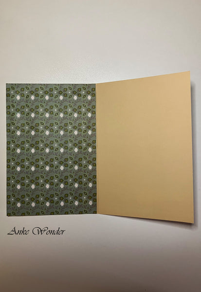Green and white floral inside of a greeting card.