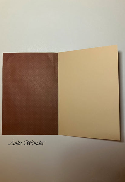 Dark red paper with dots inside of a greeting card.