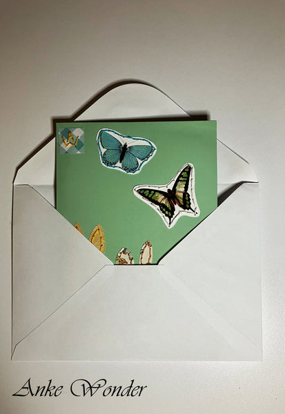 Green Card with Butterflies inside a white envelope.
